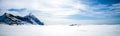 Wonderful panorama of snowy Mount Aspiring with the sea of Ã¢â¬â¹Ã¢â¬â¹clouds below taken on a sunny winter day in Wanaka, New Zealand Royalty Free Stock Photo